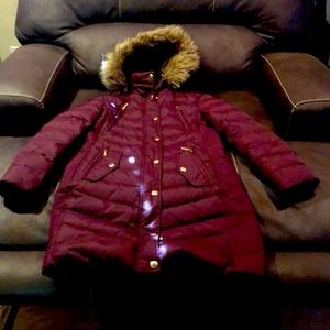 A maroon colored jacked, Michael Kors size small. Never been used